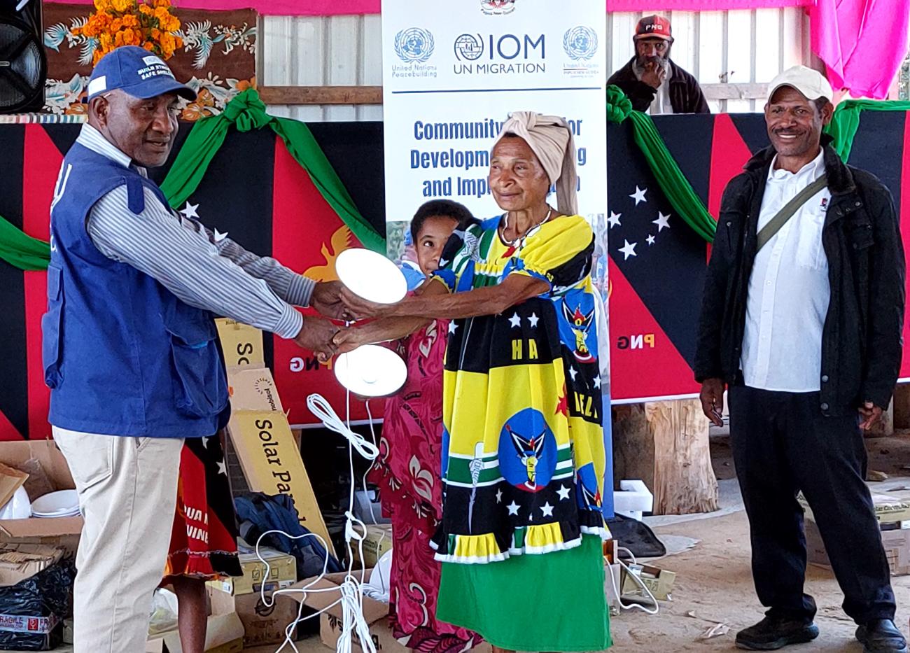 Guala community members welcome solar lighting kits from IOM_4