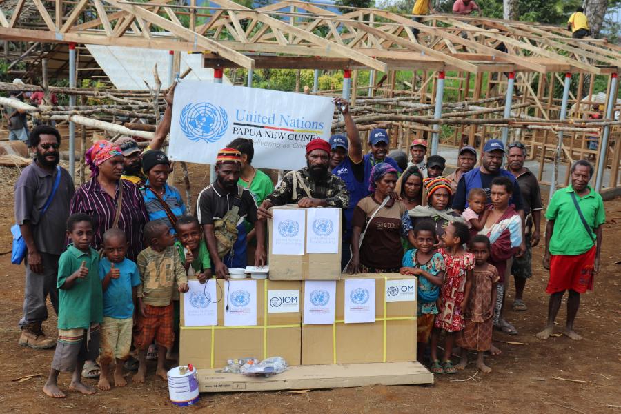 People stand with boxes of supplies from United Nations