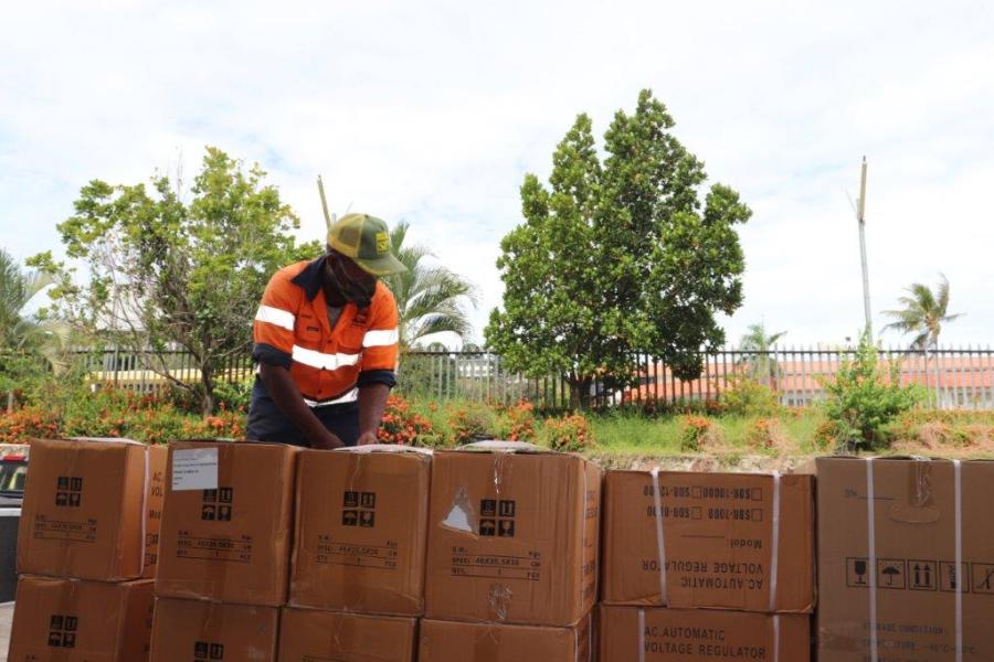 Man unloads boxes from truck.