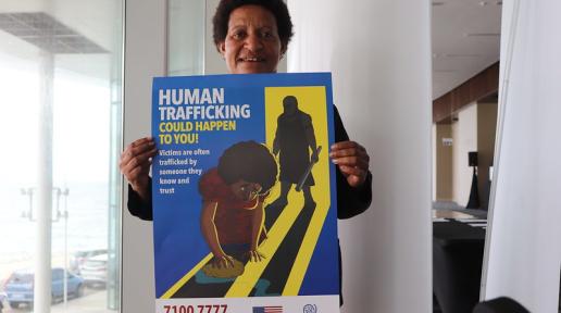 Woman holds poster on human trafficking