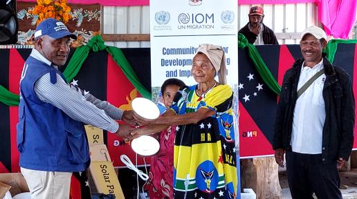 Guala community members welcome solar lighting kits from IOM_4